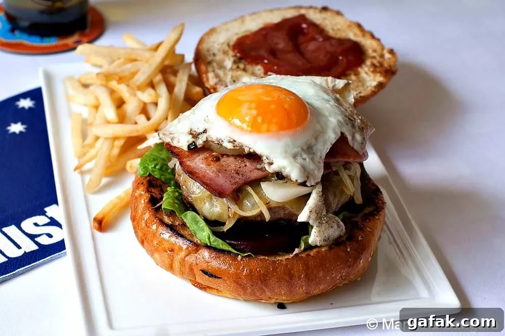 Rissoles: Crispy Filled Patties Recipe Guide 5 Classic Australian burger topped with fried egg, bacon, and onion, served with fries.