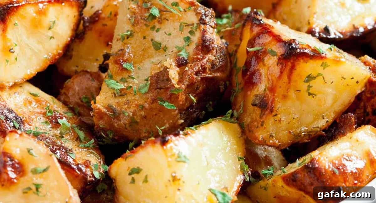 Up close image of ranch roasted potatoes with garnish. 