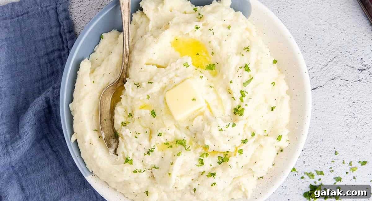 Overhead image of Idahoan mashed potatoes with garnish and butter.