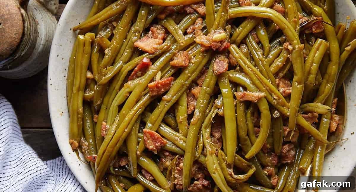 Overhead image of crockpot green beans in white dish. 