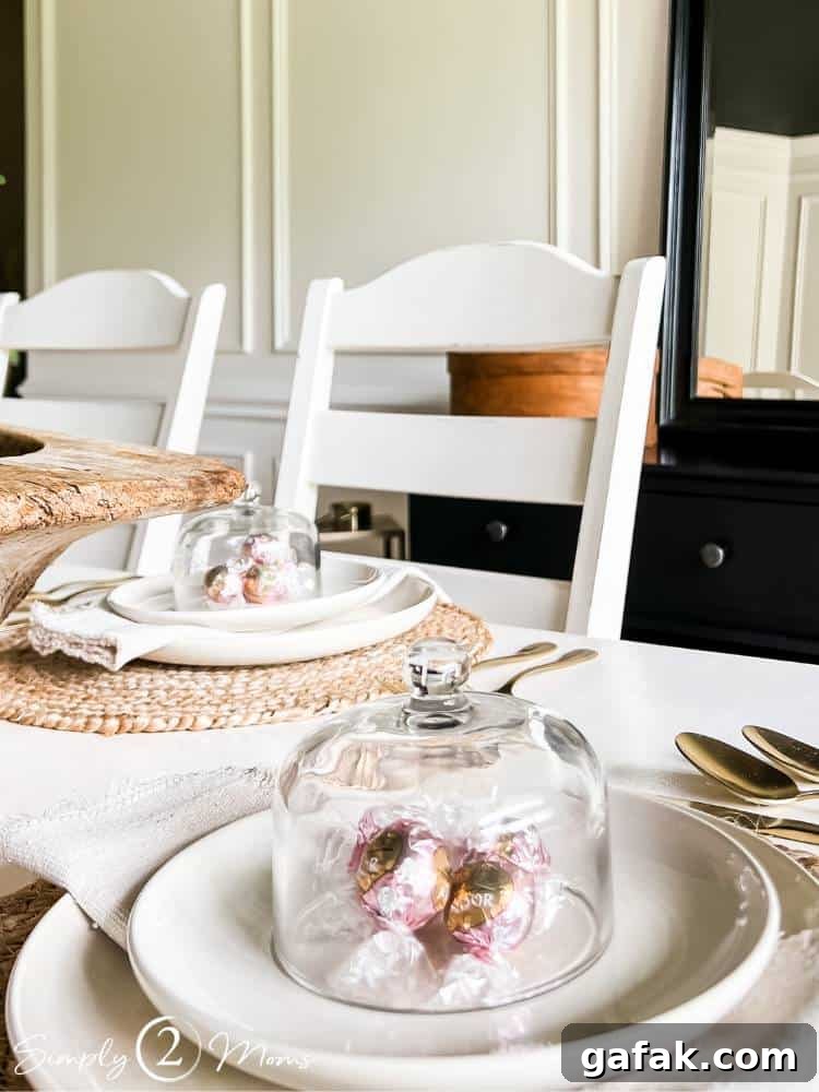 table place settings with candy under glass cloche on plate