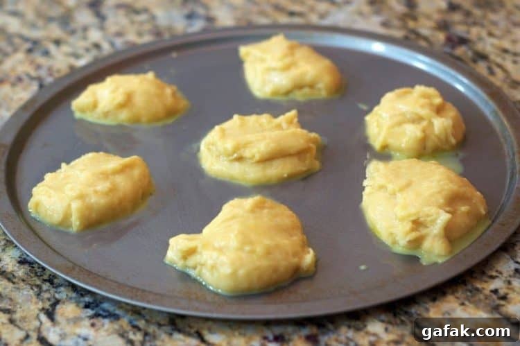 Strawberry Cream Puffs from the State Fair Recipe 6 A baking sheet with unbaked dough on it