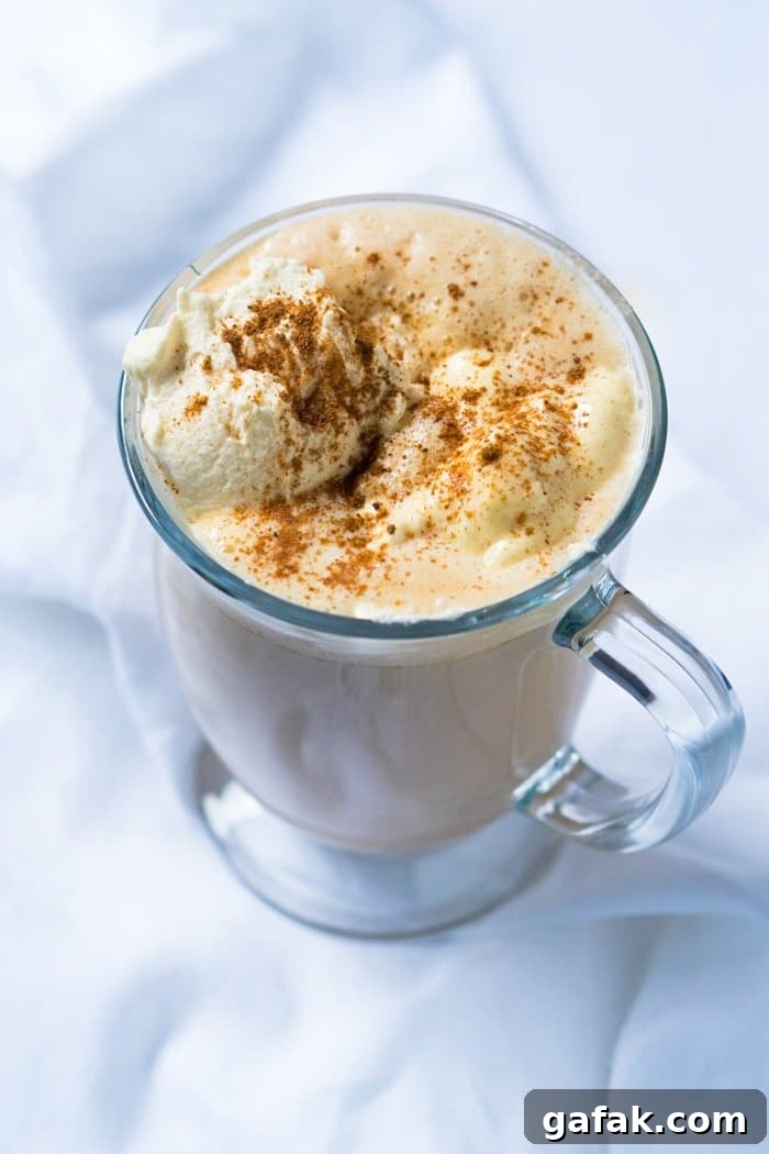 Paleo & keto pumpkin spice latte in a glass mug with whipped cream