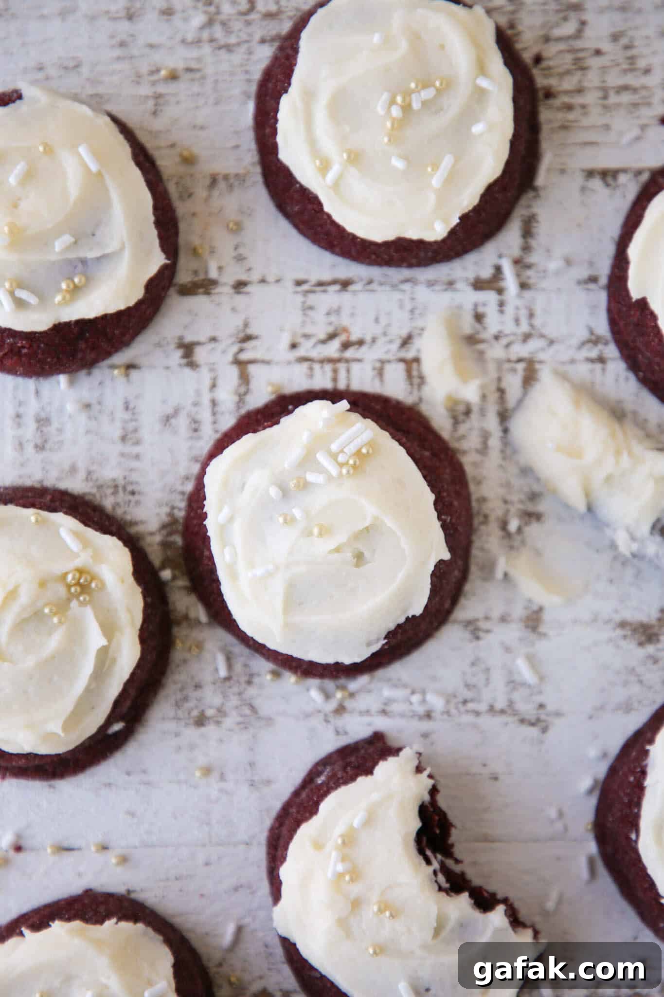 Red velvet cookies grouped on a beige backdrop.