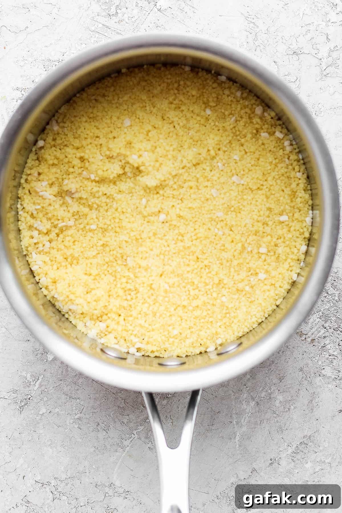 Steamed couscous in the sauce pan.