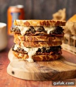 two haggis sandwiches stacked on each other on wooden board