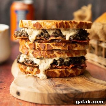 two haggis sandwiches stacked on each other on wooden board