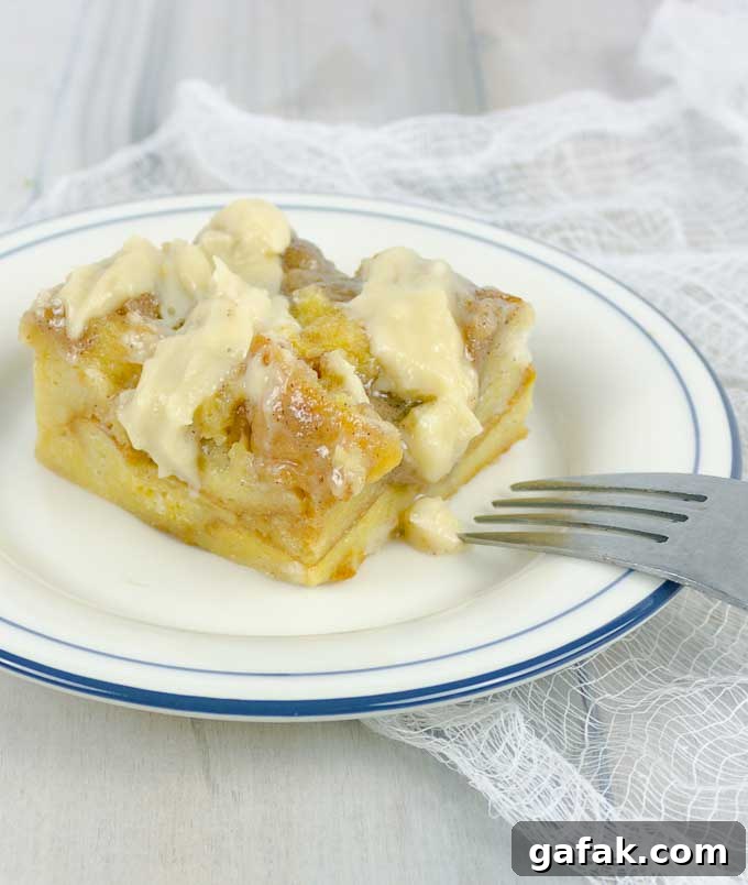Irish Cream Custard Bread Pudding on white plate with fork