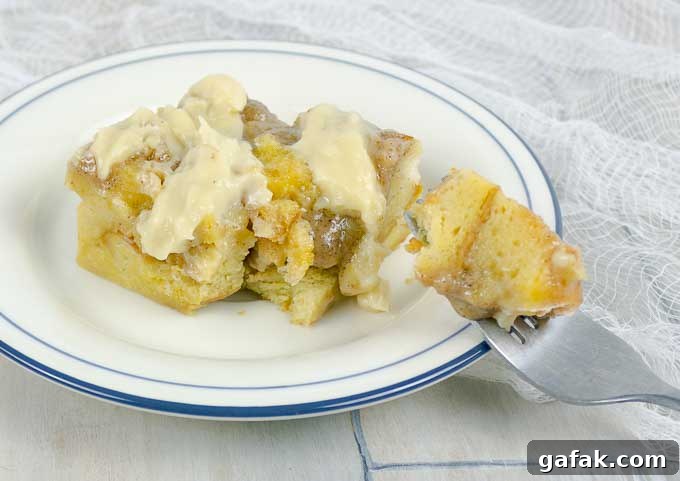 Irish Cream Custard Bread Pudding on white plate with fork