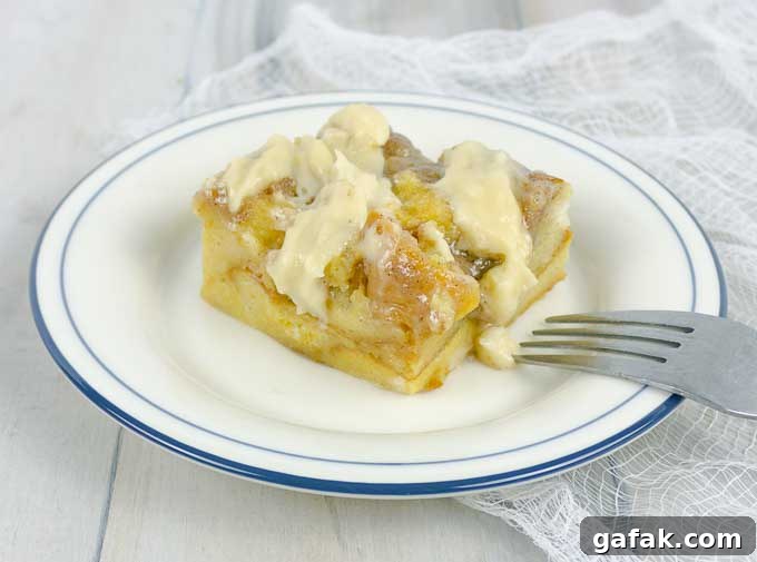 Irish Cream Custard Bread Pudding on white plate with fork