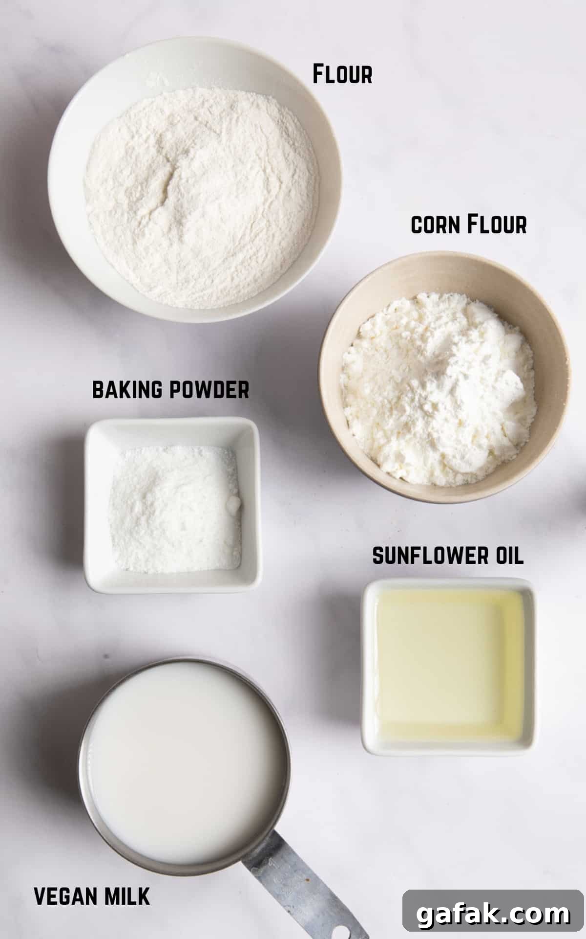 ingredients laid on white background to make Yorkshire puddings.