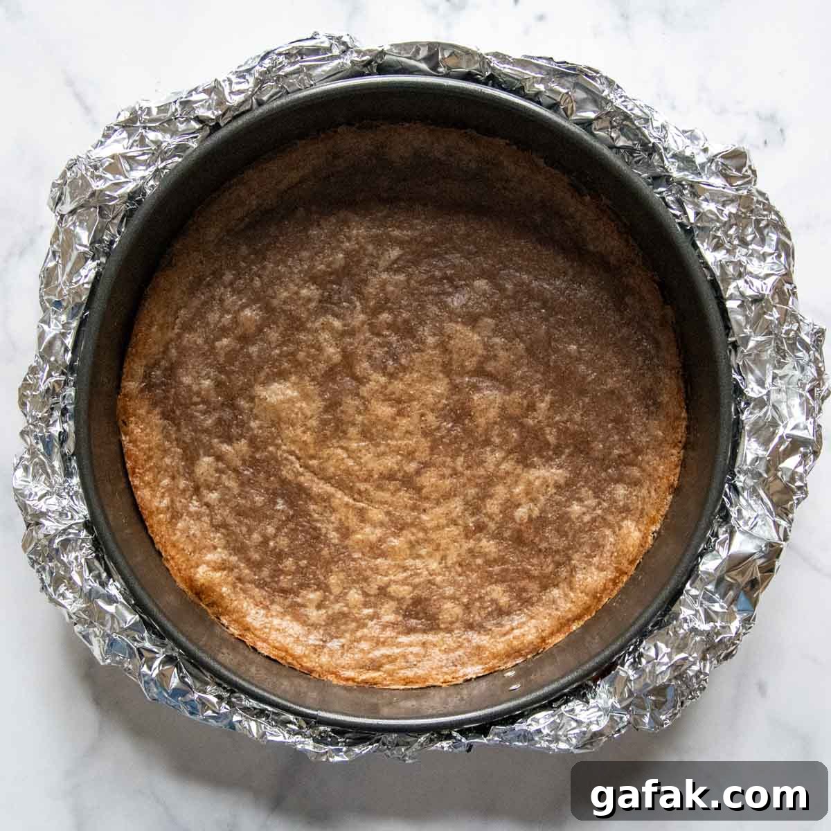 bake cheesecake crust with foil around the pan.
