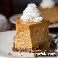 a slice of cheesecake with a bite taken out facing the viewer.