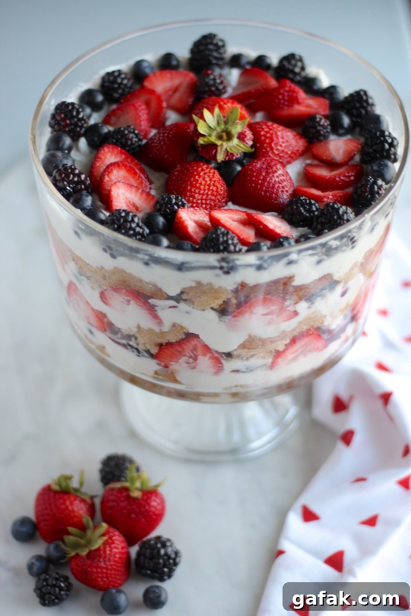 Paleo Triple Berry Trifle (AIP) - a luscious, yet healthy dessert featuring fresh berries, coconut whipped cream, homemade berry compote, and coconut honey pound cake! | fedandfulfilled.com
