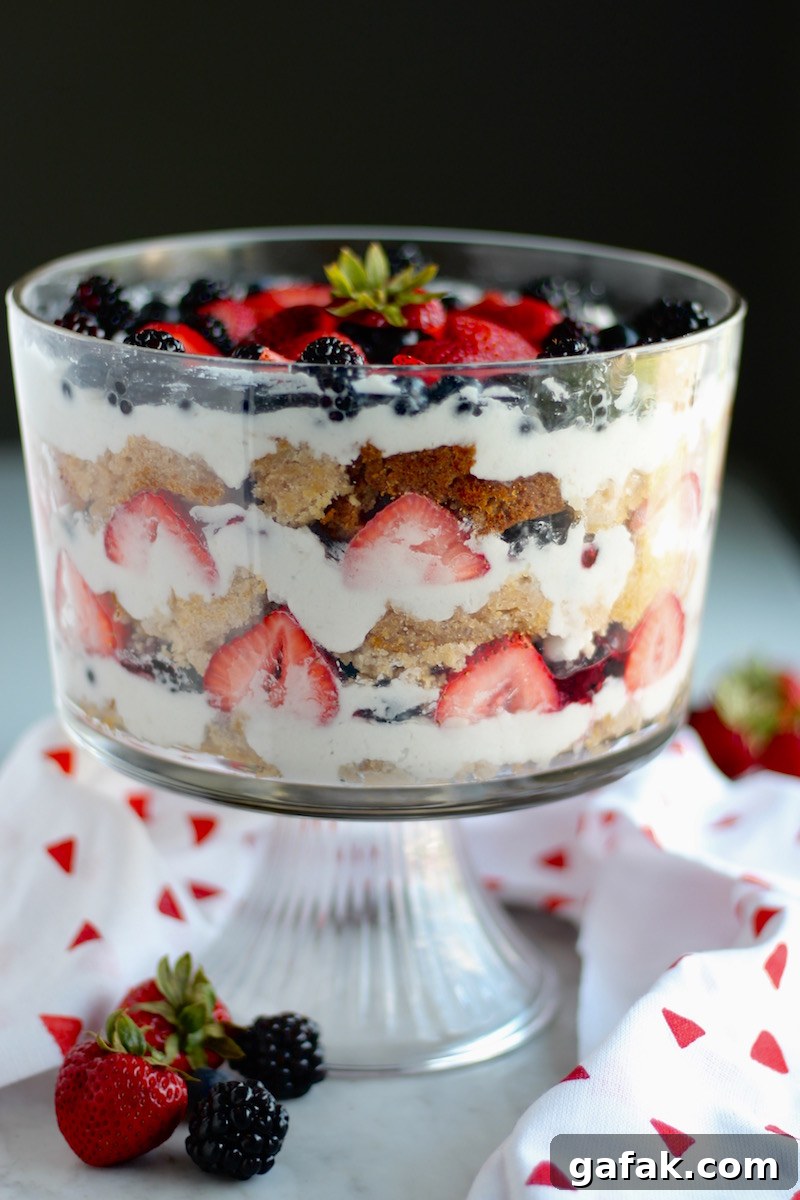 Paleo Triple Berry Trifle (AIP) - a decadent layered dessert of coconut honey sponge cake, whipped coconut cream, fresh berries, and homemade berry jam! YUM! | fedandfulfilled.com