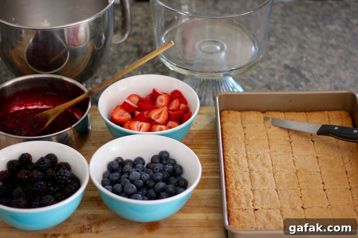 Paleo Triple Berry Trifle (AIP) - a delicious summer dessert filled with fresh berries, sponge cake, and coconut whip! | fedandfulfilled.com