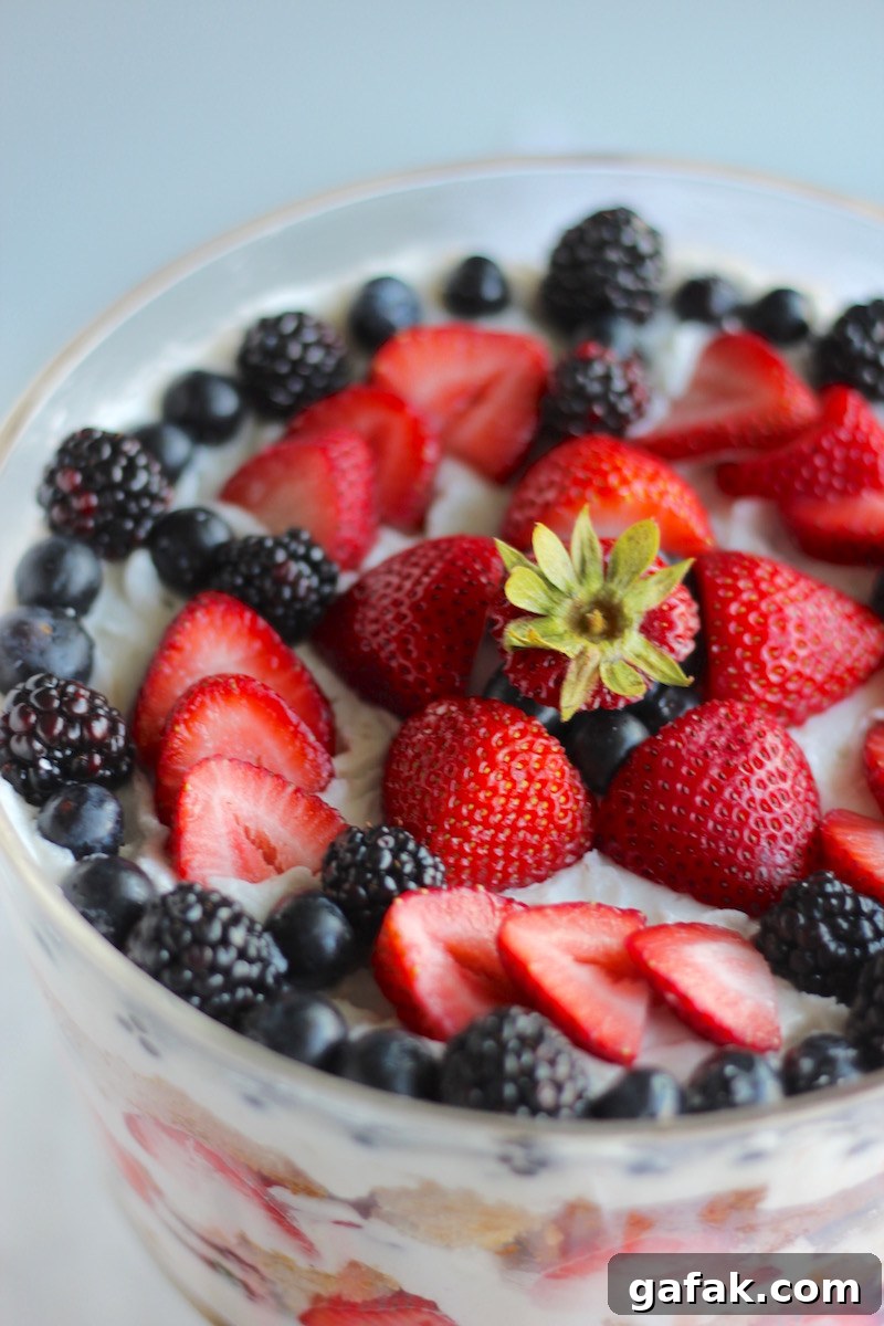 Paleo Triple Berry Trifle (AIP) - a lovely layered dessert made of juicy berries, coconut whipped cream, and coconut honey pound cake! | fedandfulfilled.com