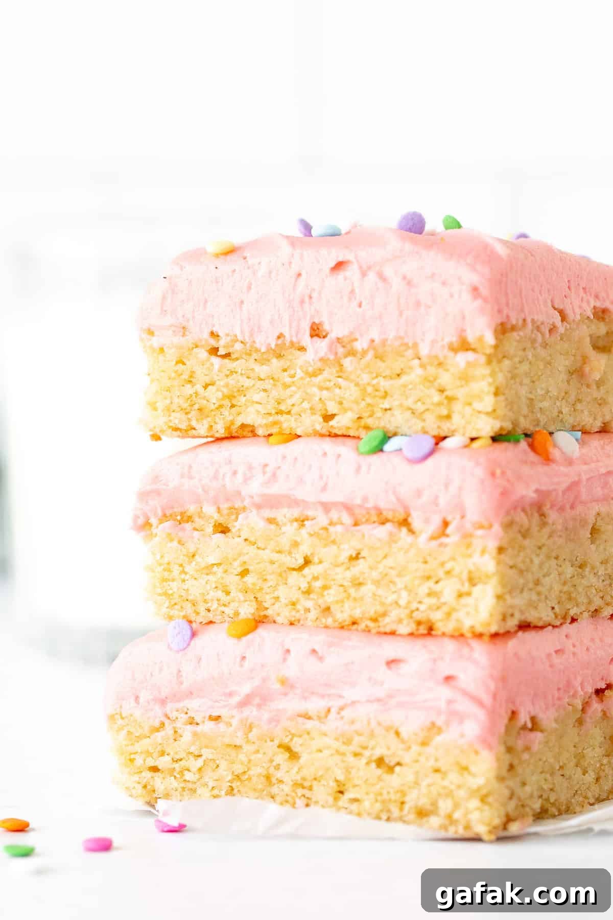Three frosted sugar cookie bars, one on top of each other