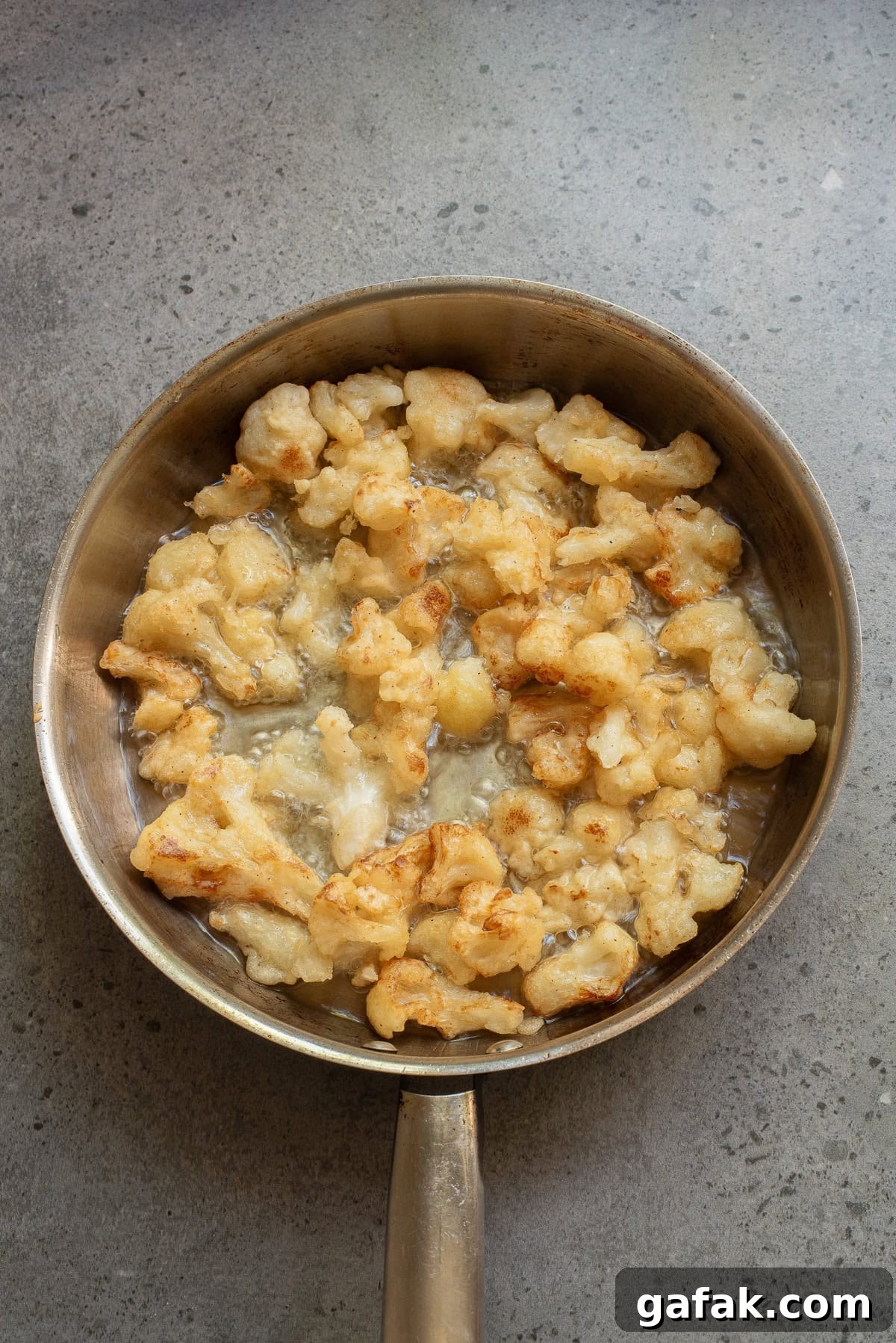 An overhead image of frying the cauliflower. 