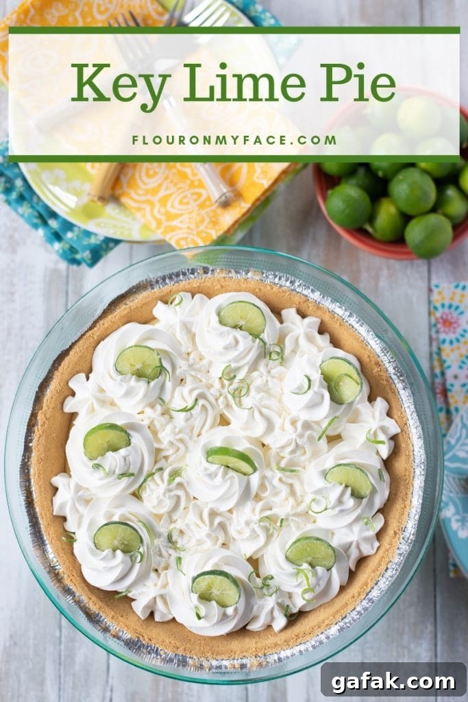 Key Lime Pie topped with whipped cream and garnished with Key lime slices