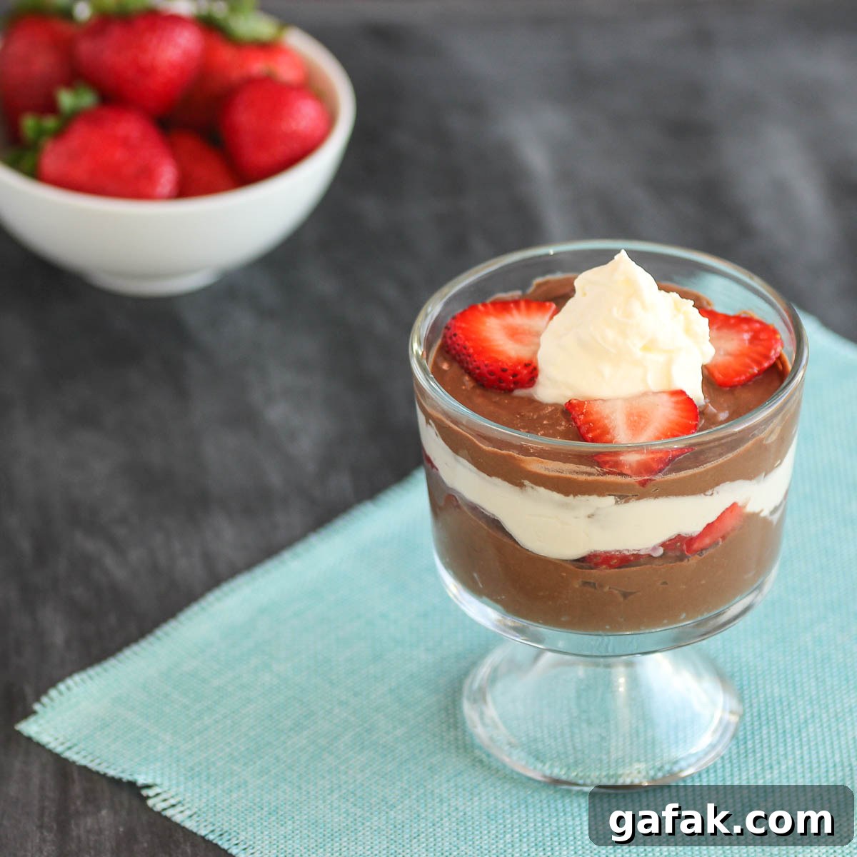 Paleo Chocolate-Strawberry Parfait Recipe for Clean Eating 3 A creamy chocolate pudding with whipped cream and sliced strawberry parfait.