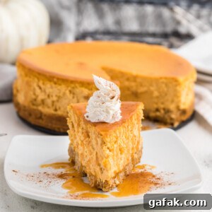 Slice of air fryer pumpkin cheesecake on a white plate ready to eat.
