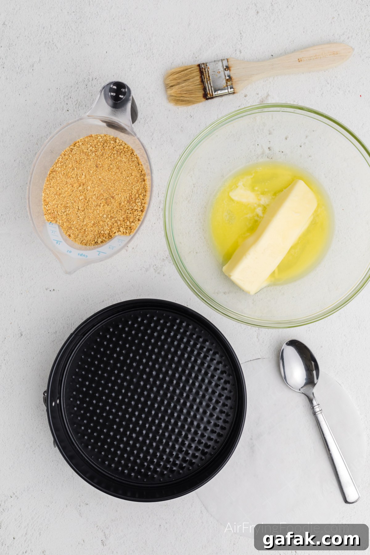 Butter and graham cracker crumbs ready to be combined and placed into the springform pan.