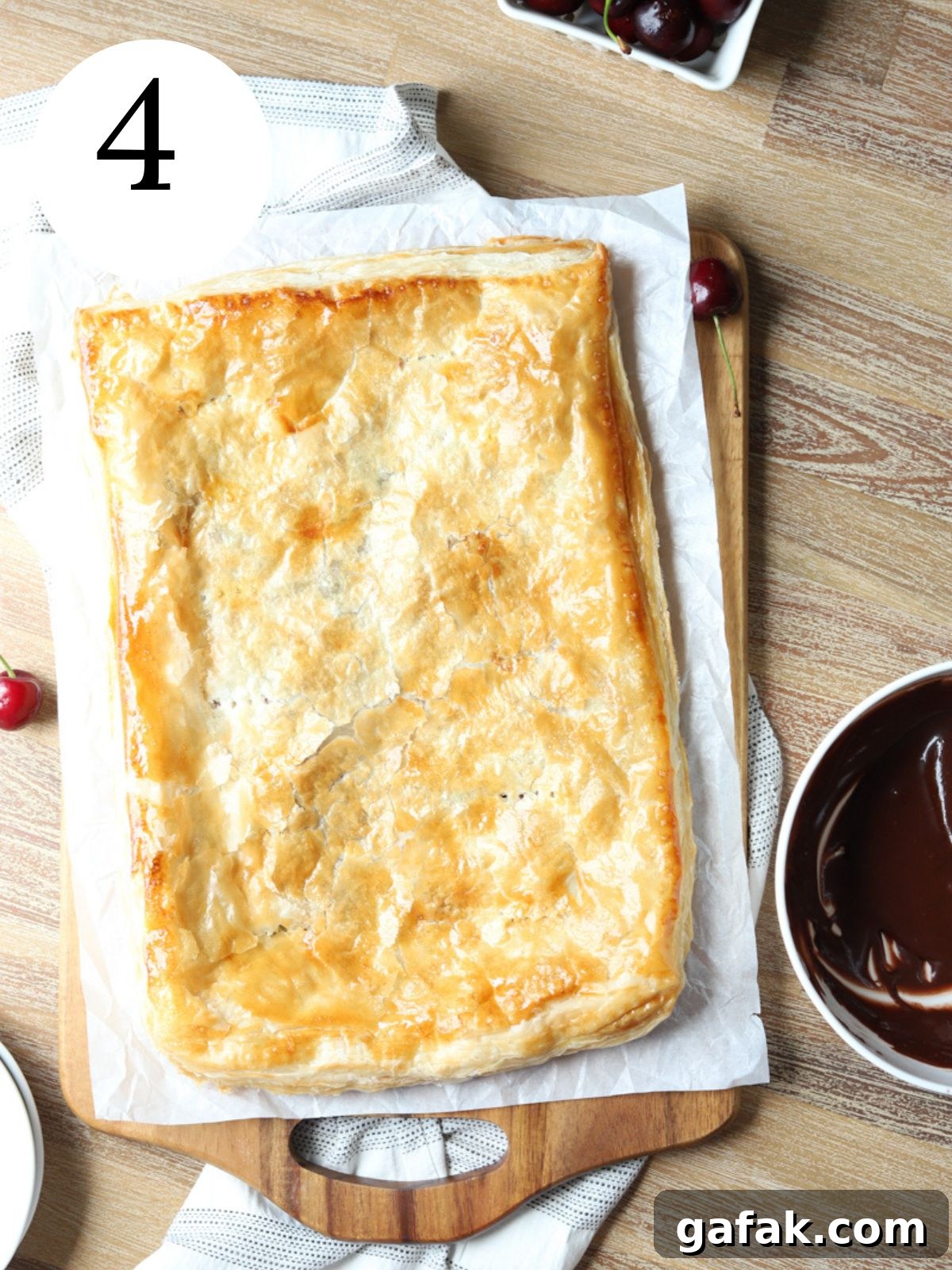 A golden brown slab pie on parchment paper. 