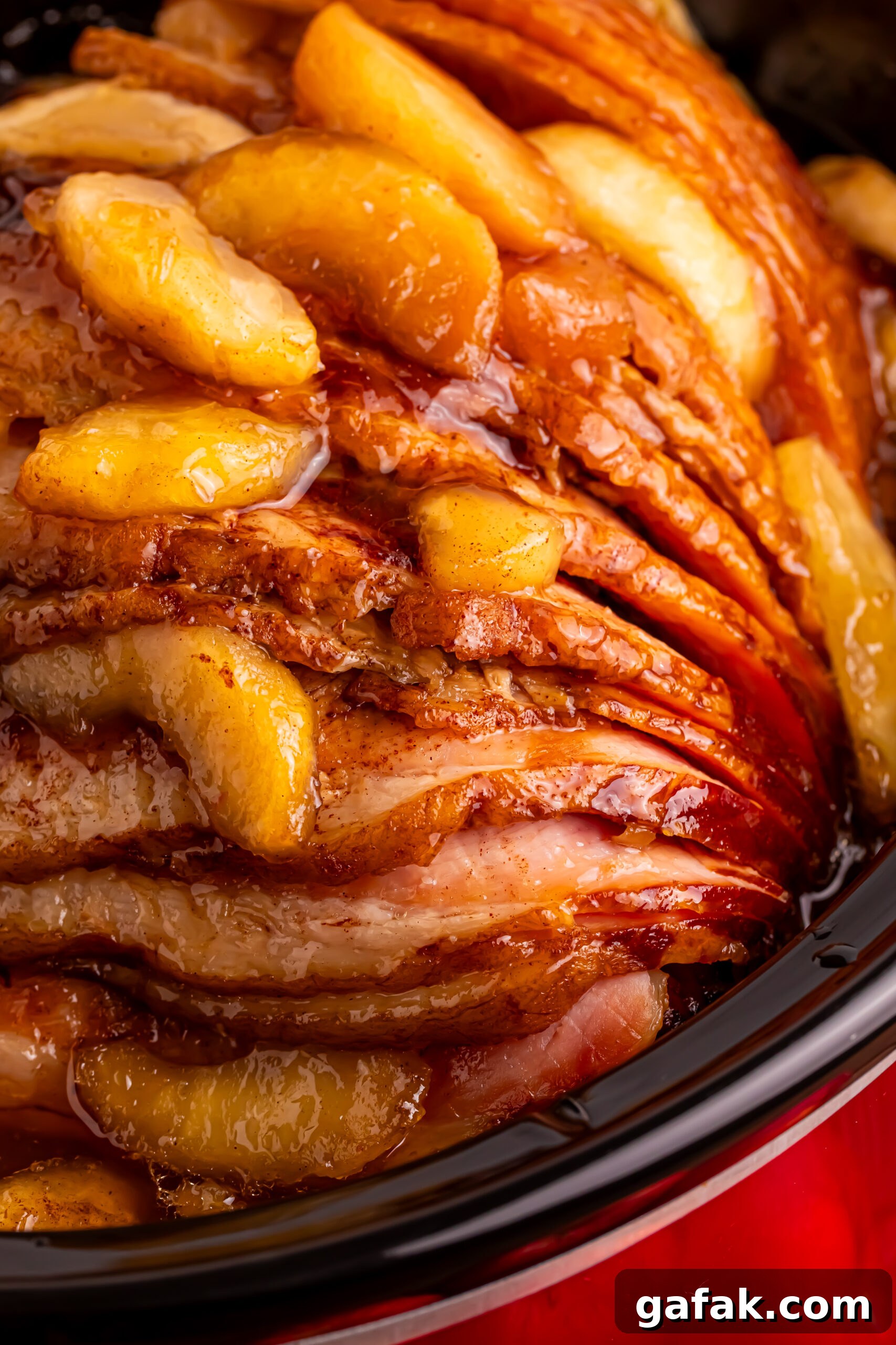 up close shot of the Slow Cooker Apple Glazed Ham in a black crock pot 