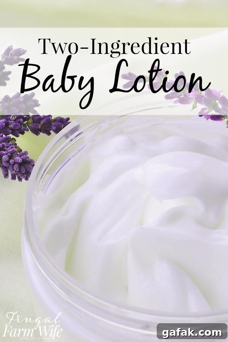 Image is an extreme close up of a jar of white, homemade baby lotion on a white cloth with some purple lavender behind it. Text overlay reads 'Two-Ingredient Baby Lotion'