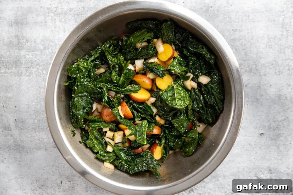 Kale, potatoes, onion, garlic and thyme in a large mixing bowl.