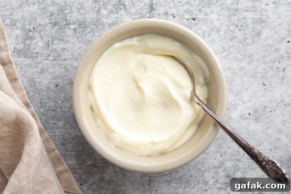 Bowl of garlic aioli with a spoon.