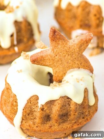 Up close view of gingerbread mini bundt cakes drizzled in white chocolate