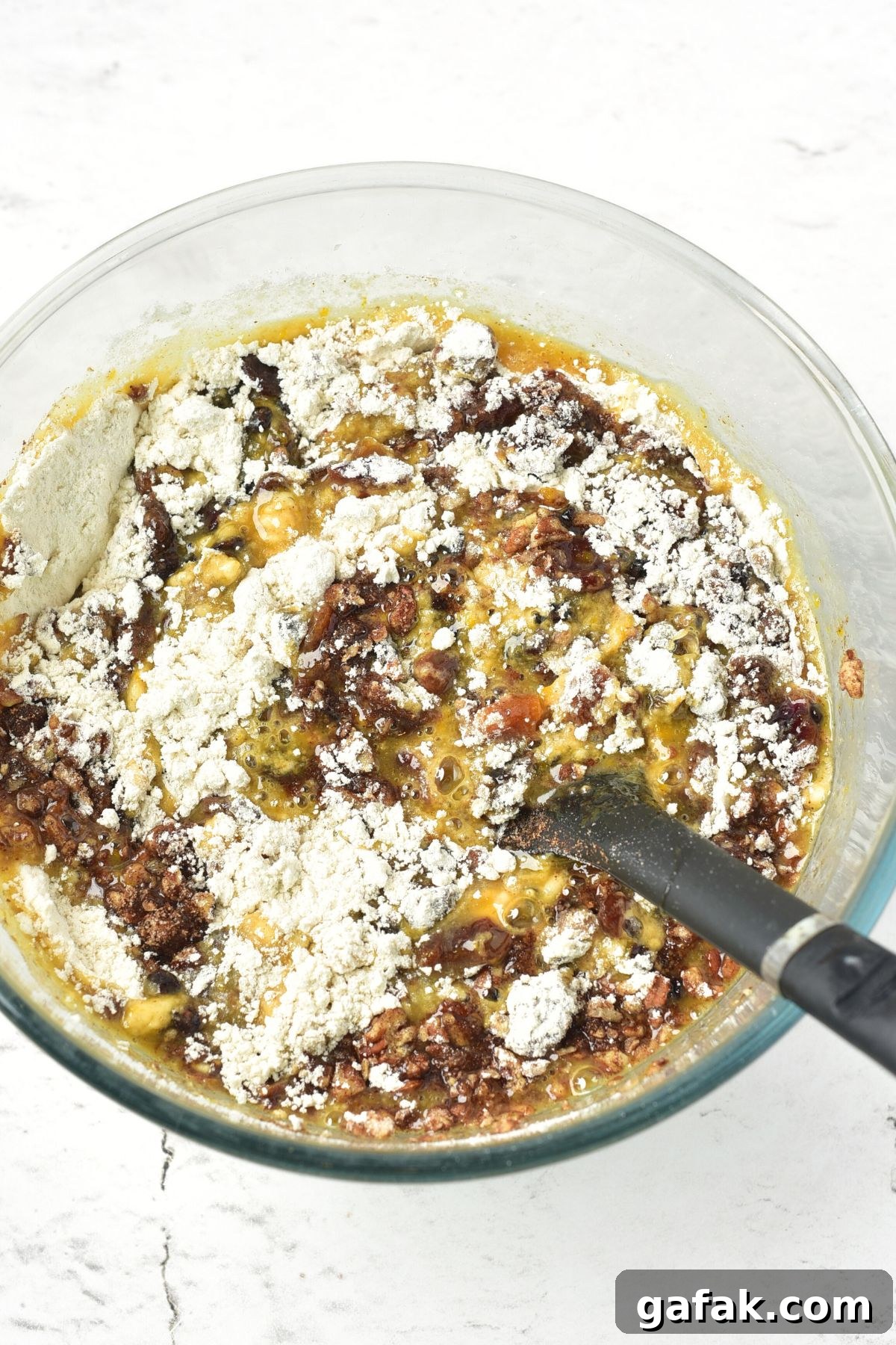 Easy Gluten-Free Fruit and Nut Cake Recipe (Dairy-Free) Mixing flour into wet ingredients