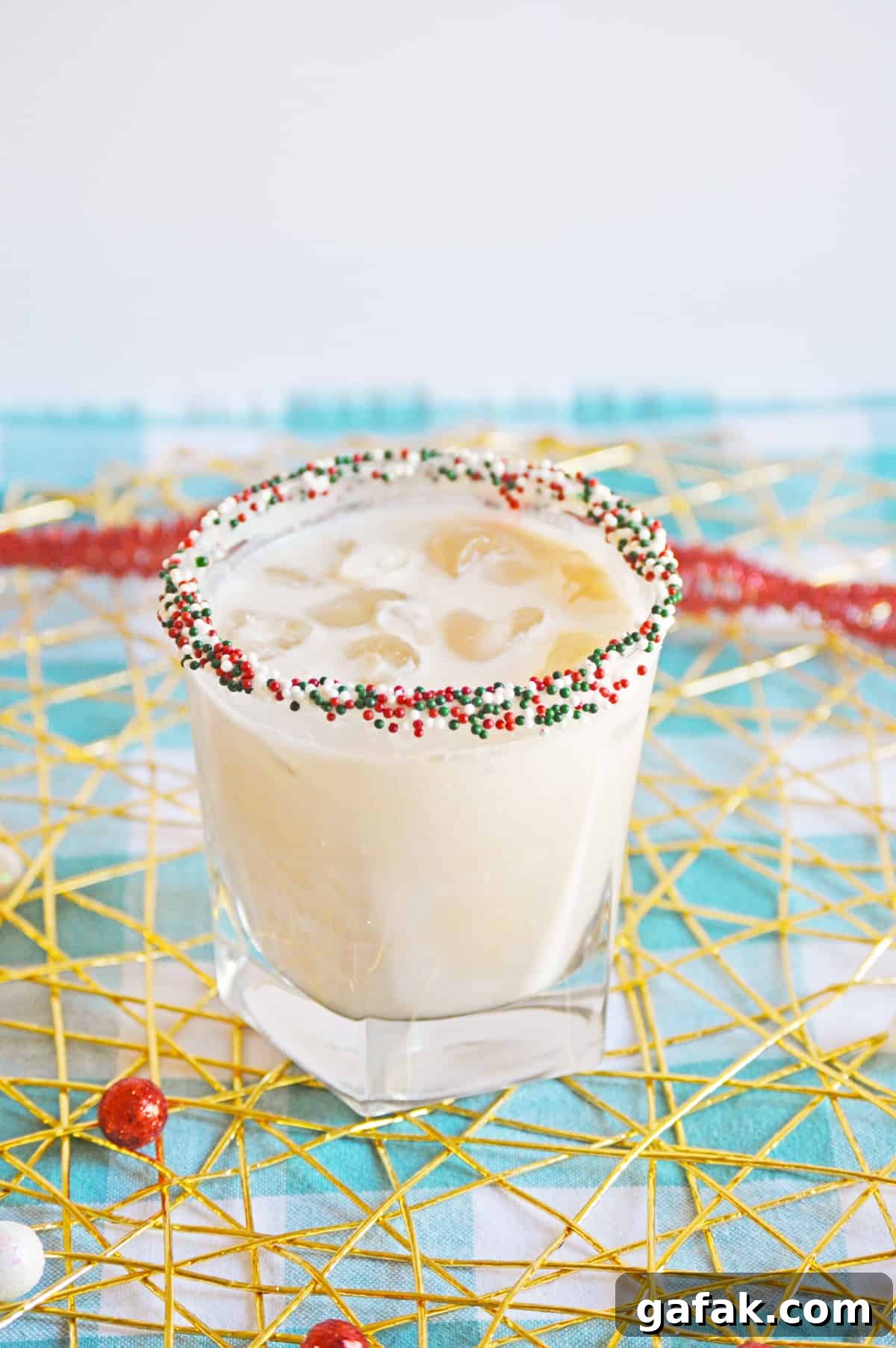Christmas Cookie Cocktail with vodka in a christmas sprinkle rimmed glass