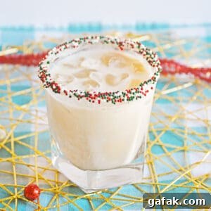Christmas Cookie Cocktail with vodka in a christmas sprinkle rimmed glass