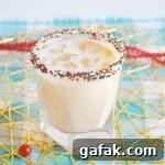 Christmas Cookie Cocktail with vodka in a christmas sprinkle rimmed glass