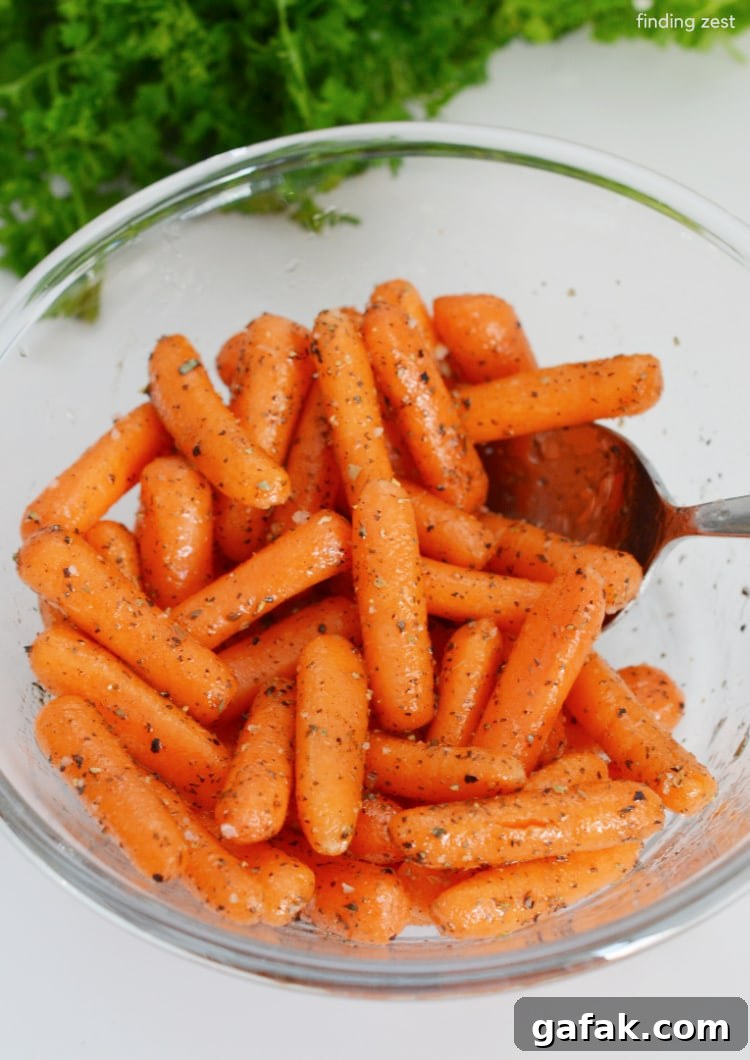 Crispy Air Fryer Baby Carrots Recipe for Quick Side Dish 6 Mixing baby carrots with olive oiil and dried herbs