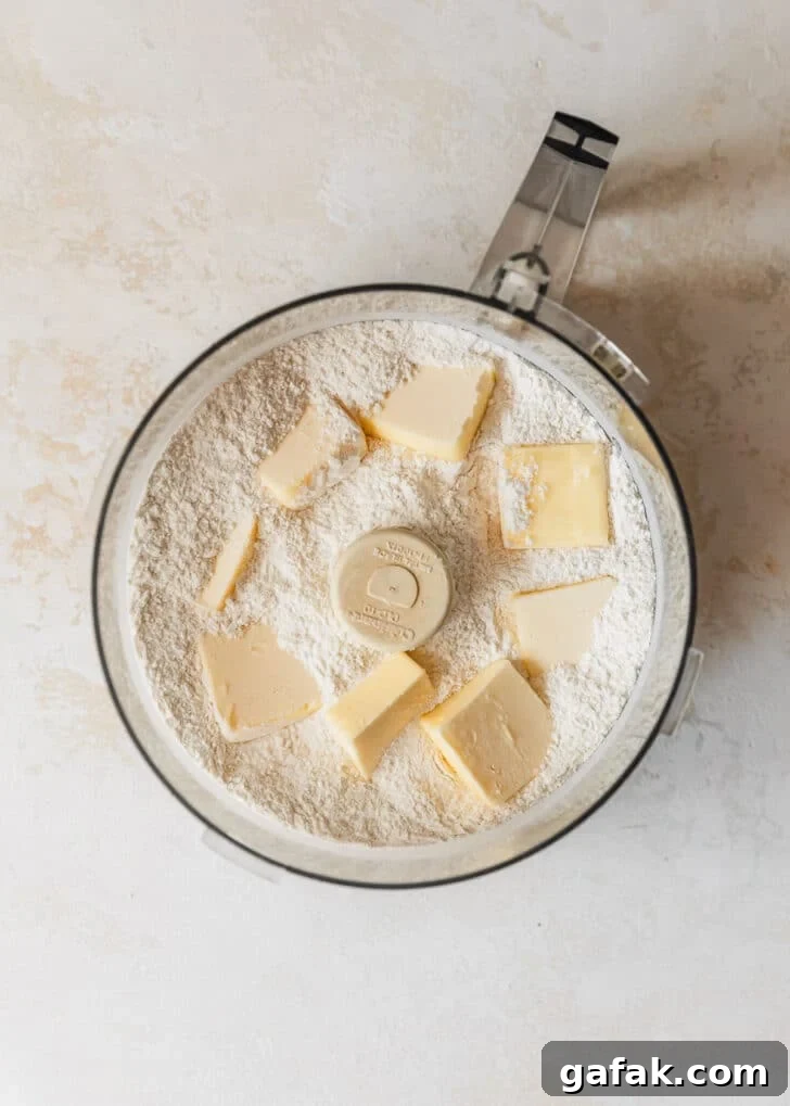 A food processor of flour and butter.