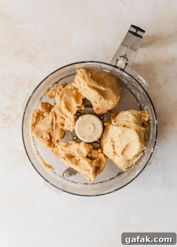 A food processor of the best pie crust on a tan counter.