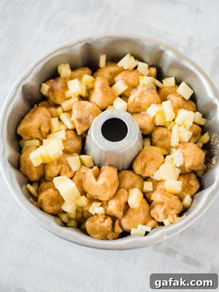 raw apple cinnamon monkey bread in a Bundt pan