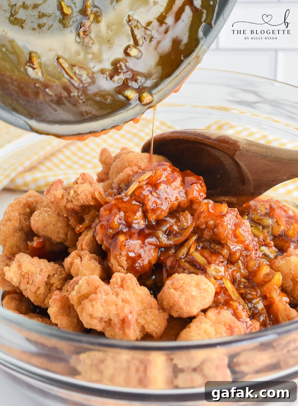 Crispy Orange Chicken Recipe with Tangy Mandarin Sauce 7 Pouring orange sauce over chicken