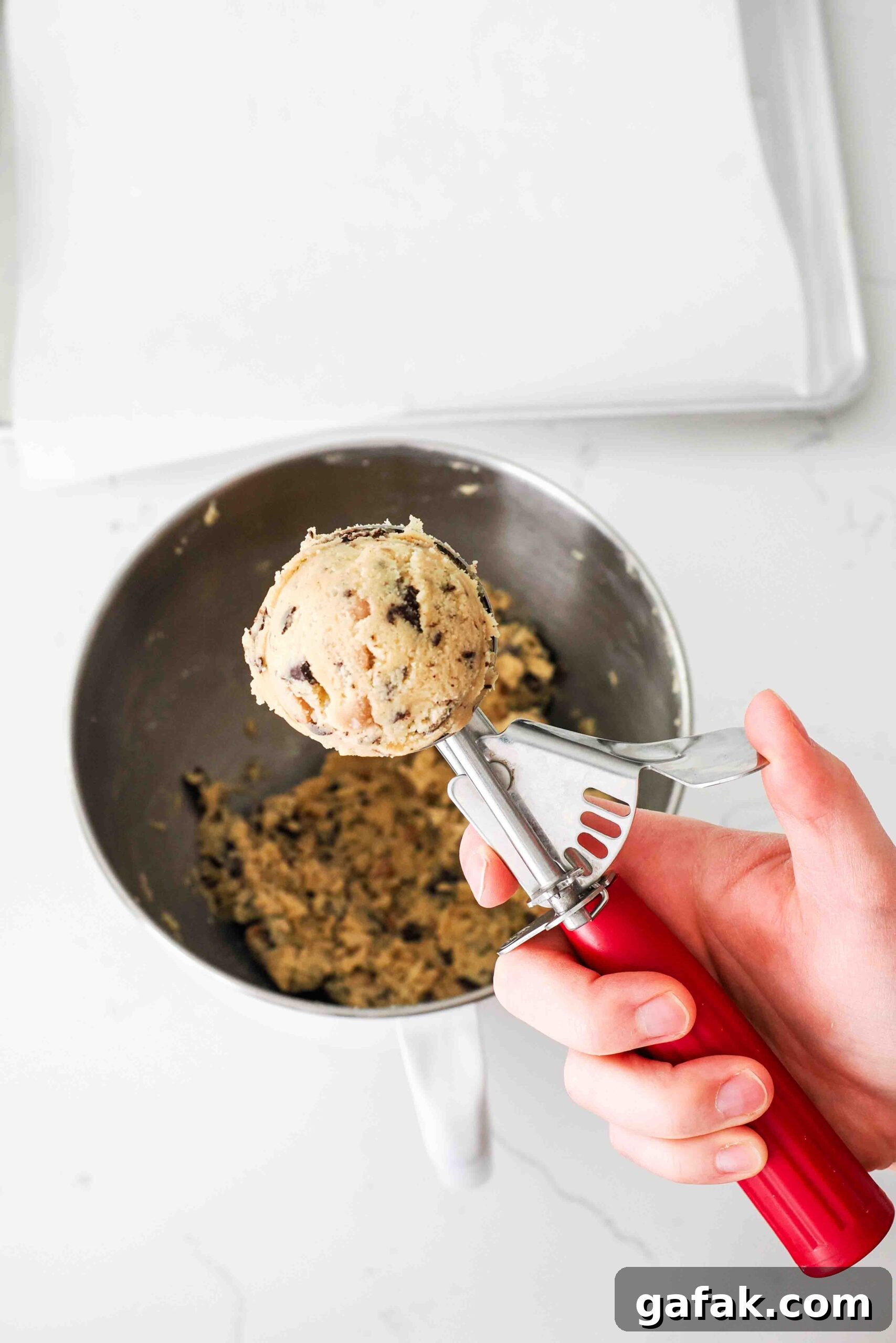 A closeup of a scoop of caramel chocolate chip cookie dough.