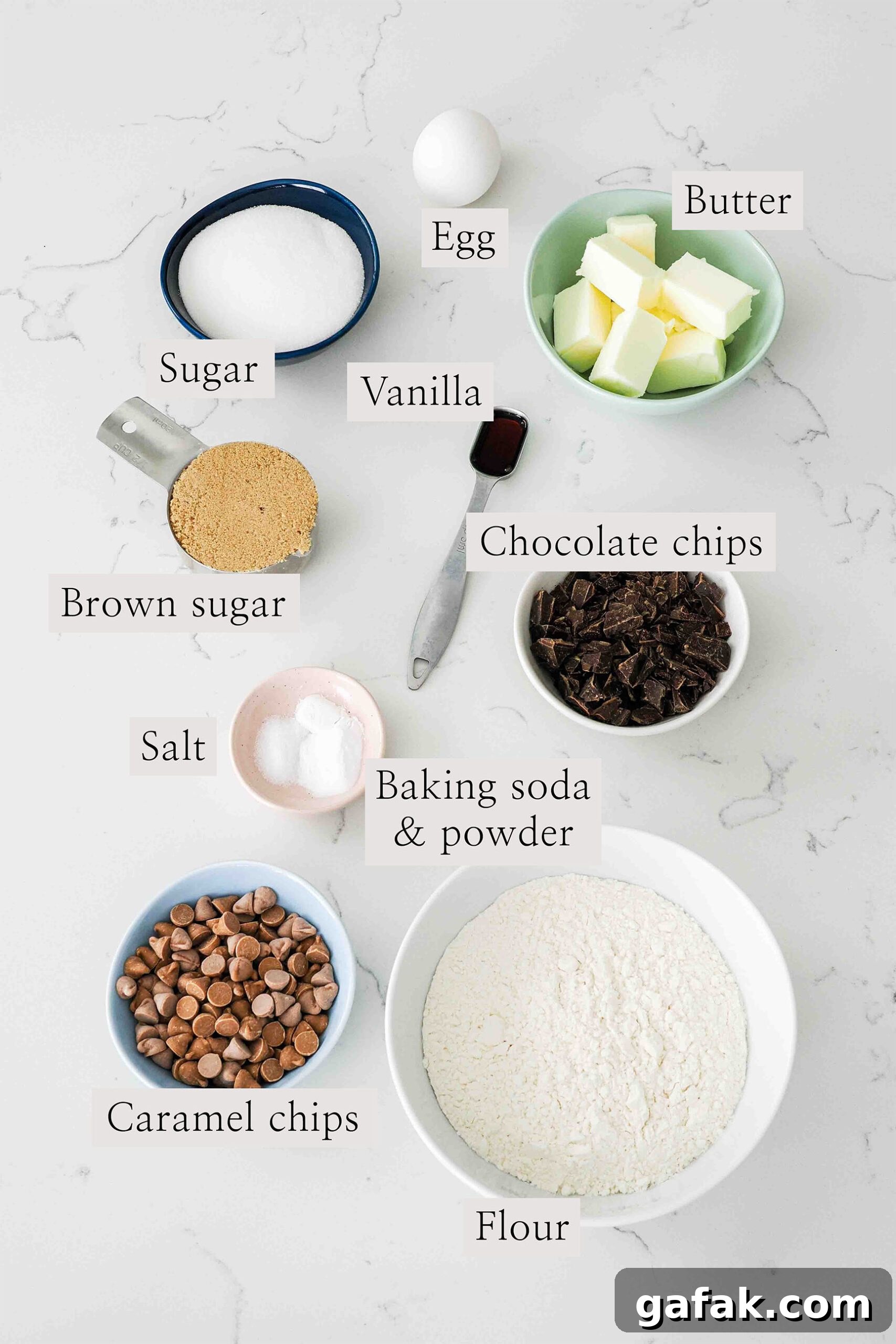 Ingredients needed to make caramel chocolate chip cookies on a quartz counter.
