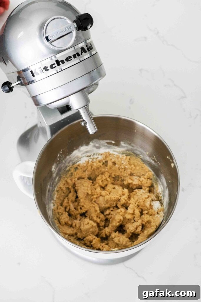 Barely mixed cookie dough in a stand mixer bowl.