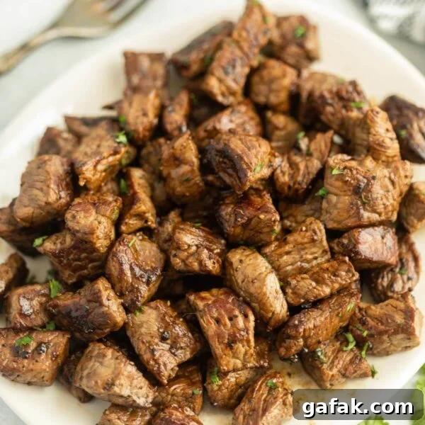 Chipotle Steak Recipe: Smoky Grilled Steak with Chili-Lime Rub 11 Grilled Steak Bites stacked on a platter.