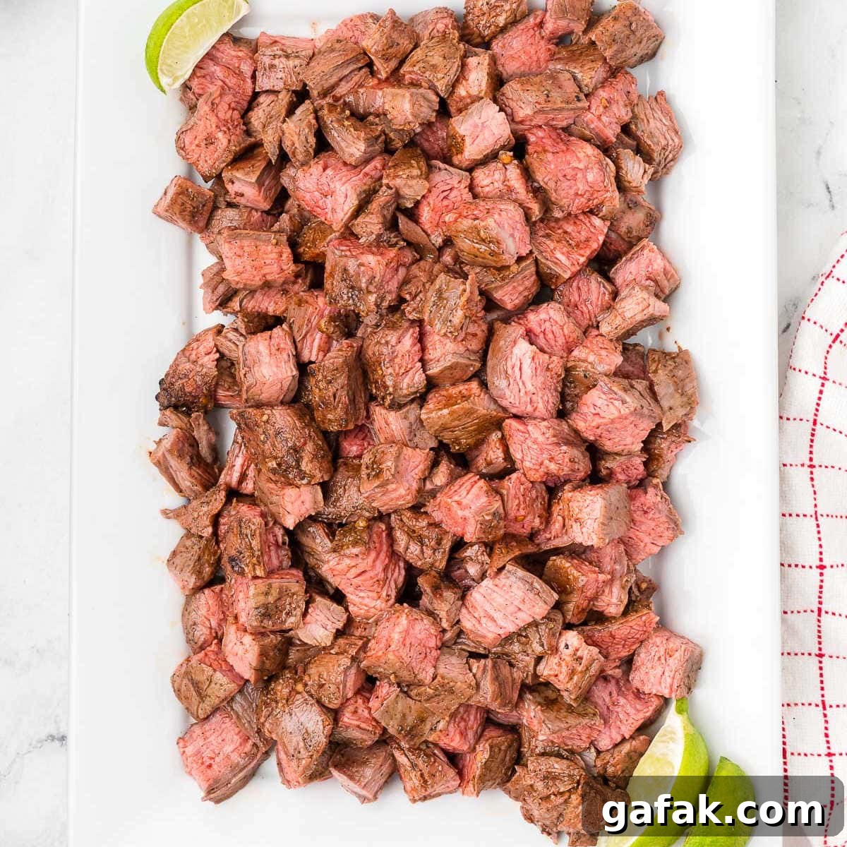 Chipotle Steak Recipe: Smoky Grilled Steak with Chili-Lime Rub 8 Chipotle Steak Bites on a white platter