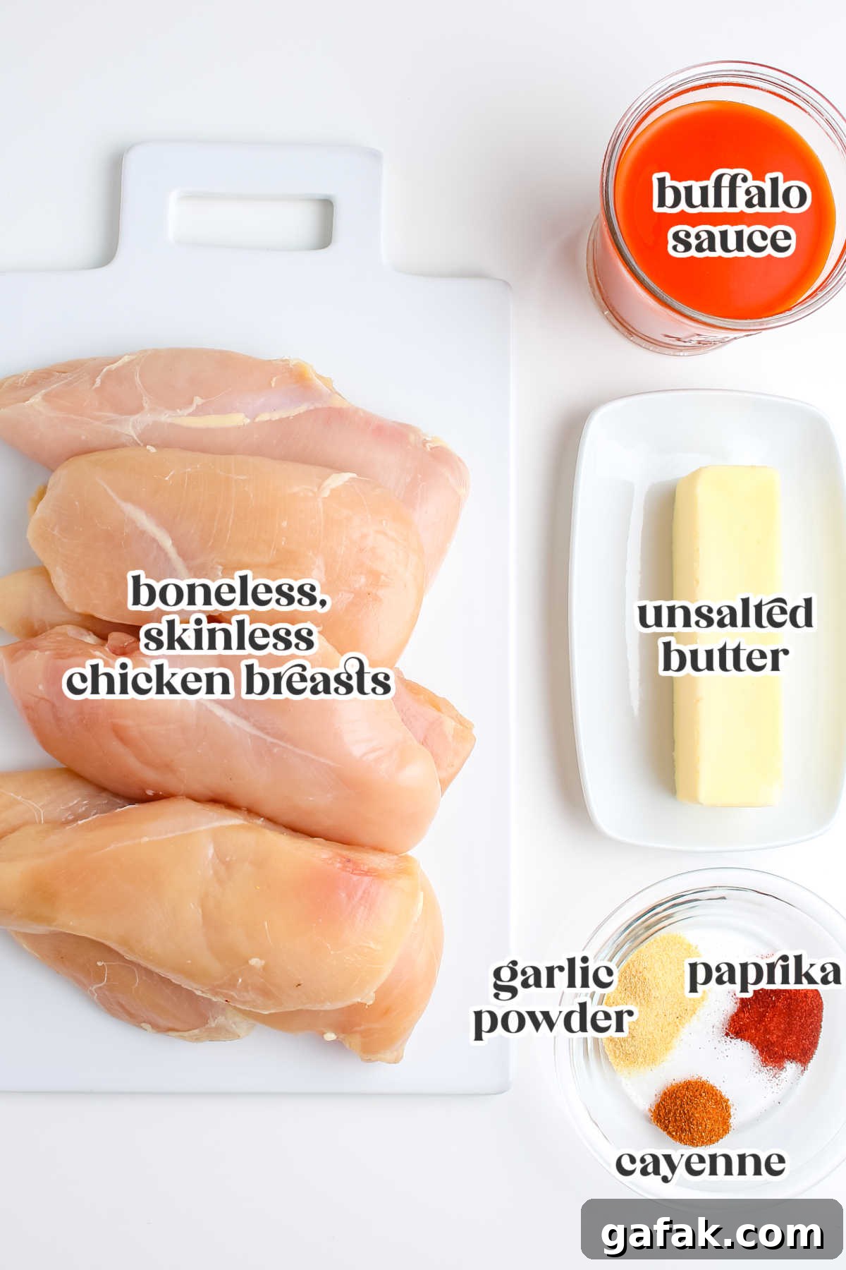 Ingredients for grilled buffalo chicken including chicken breasts, buffalo sauce, butter, garlic powder, paprika, and cayenne pepper.