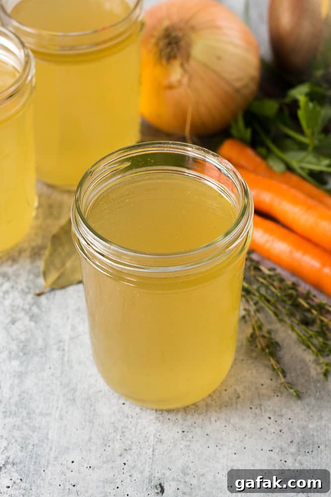turkey stock in a mason jar surrounded by ingredients