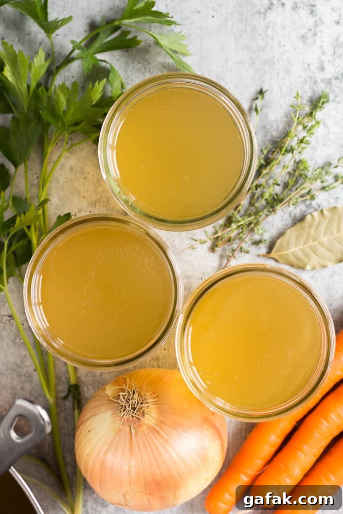 top down shot of mason jars filled with turkey stock and ingredients lying next to them